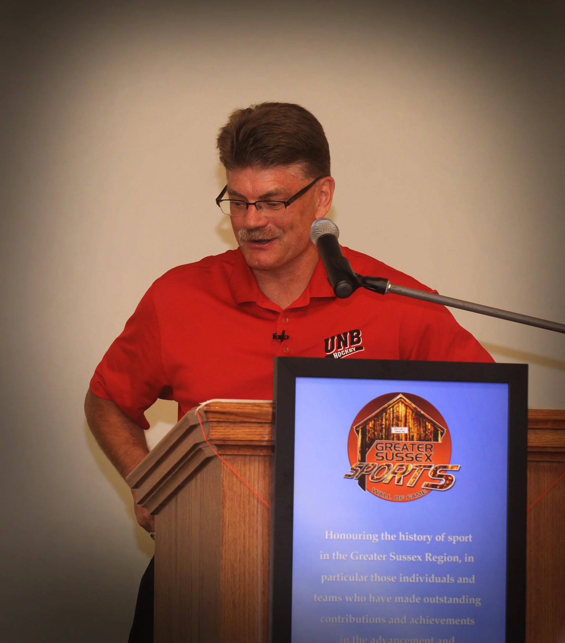 UNB Head Coach Gardiner MacDougall speaks at Wall of Fame ceremony