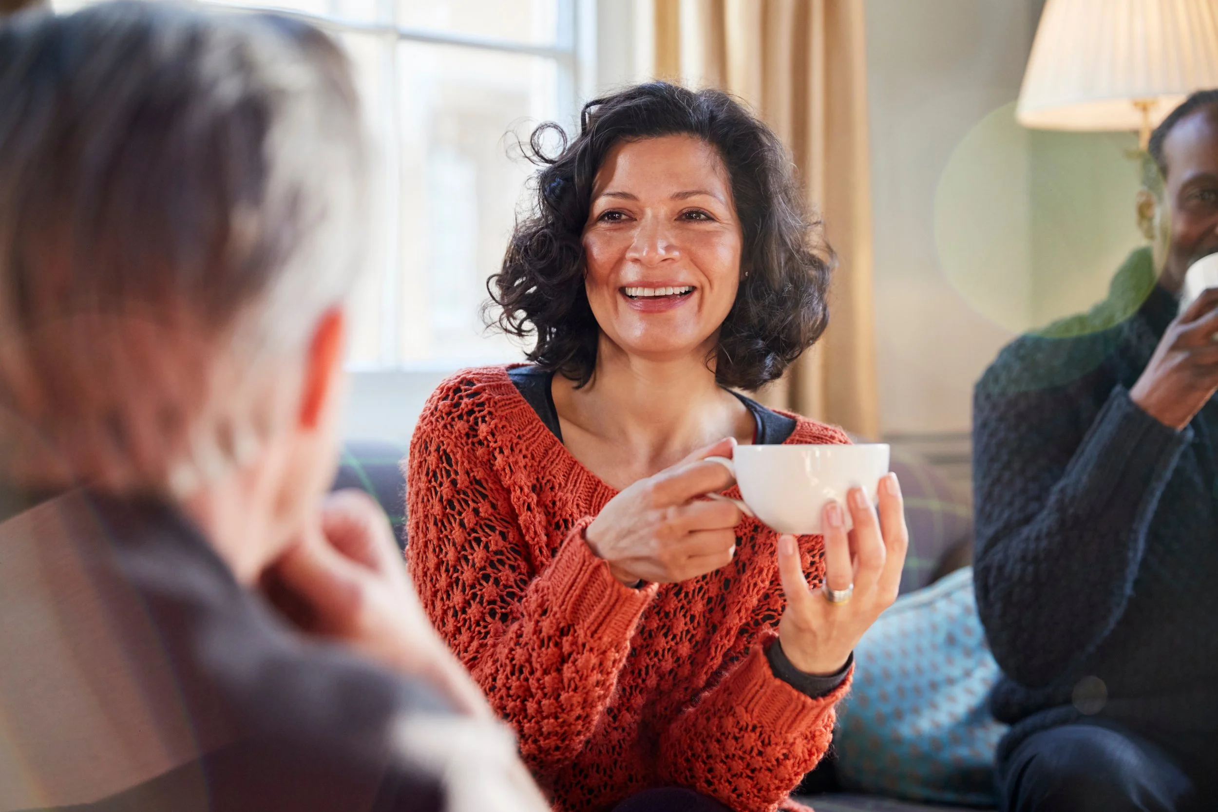 Woman enjoying a meaningful conversation with friends over coffee