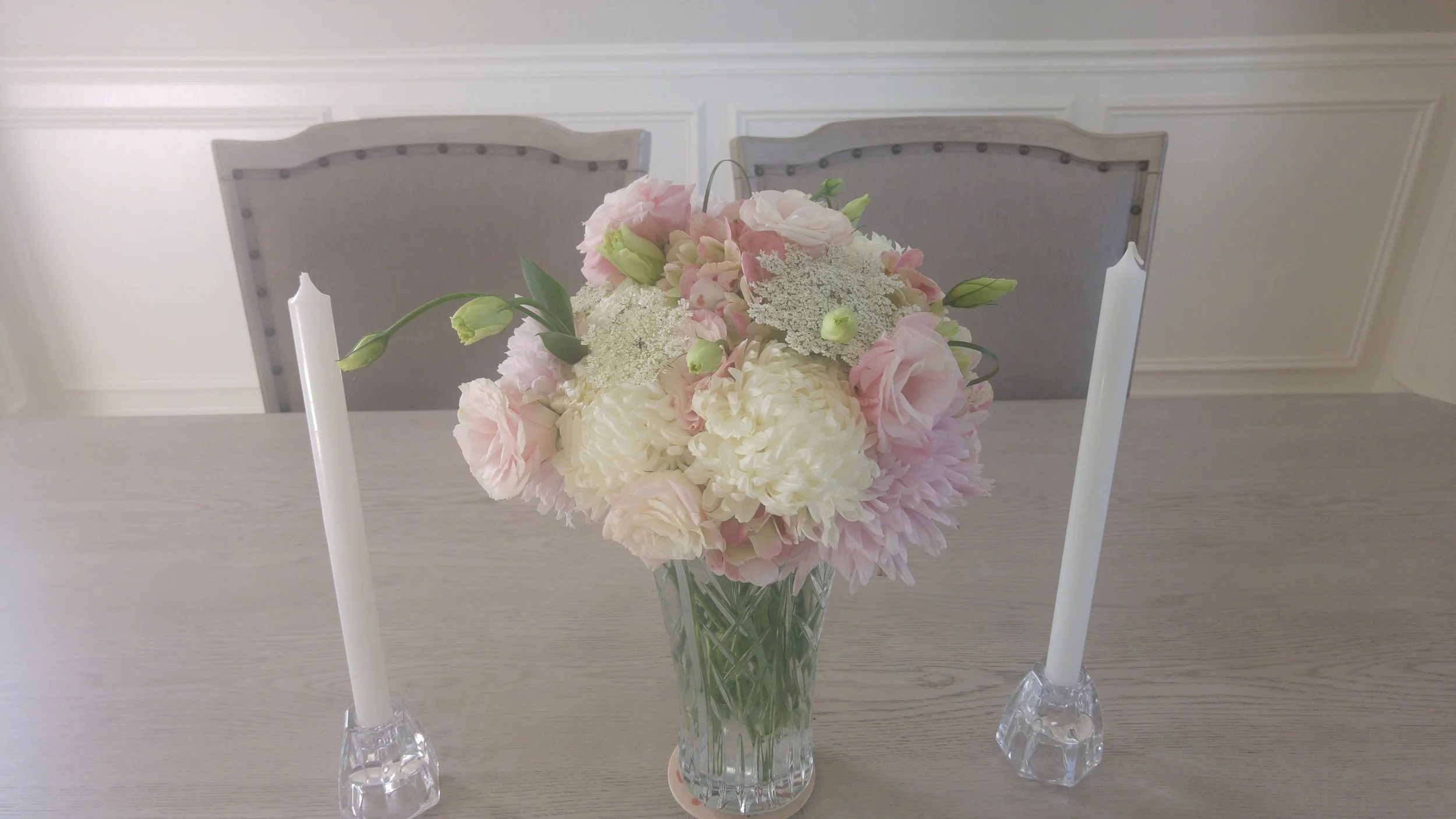 This romantic pink and white arrangement was one of two created for a housewarming party using the hosts' crystal vases. 