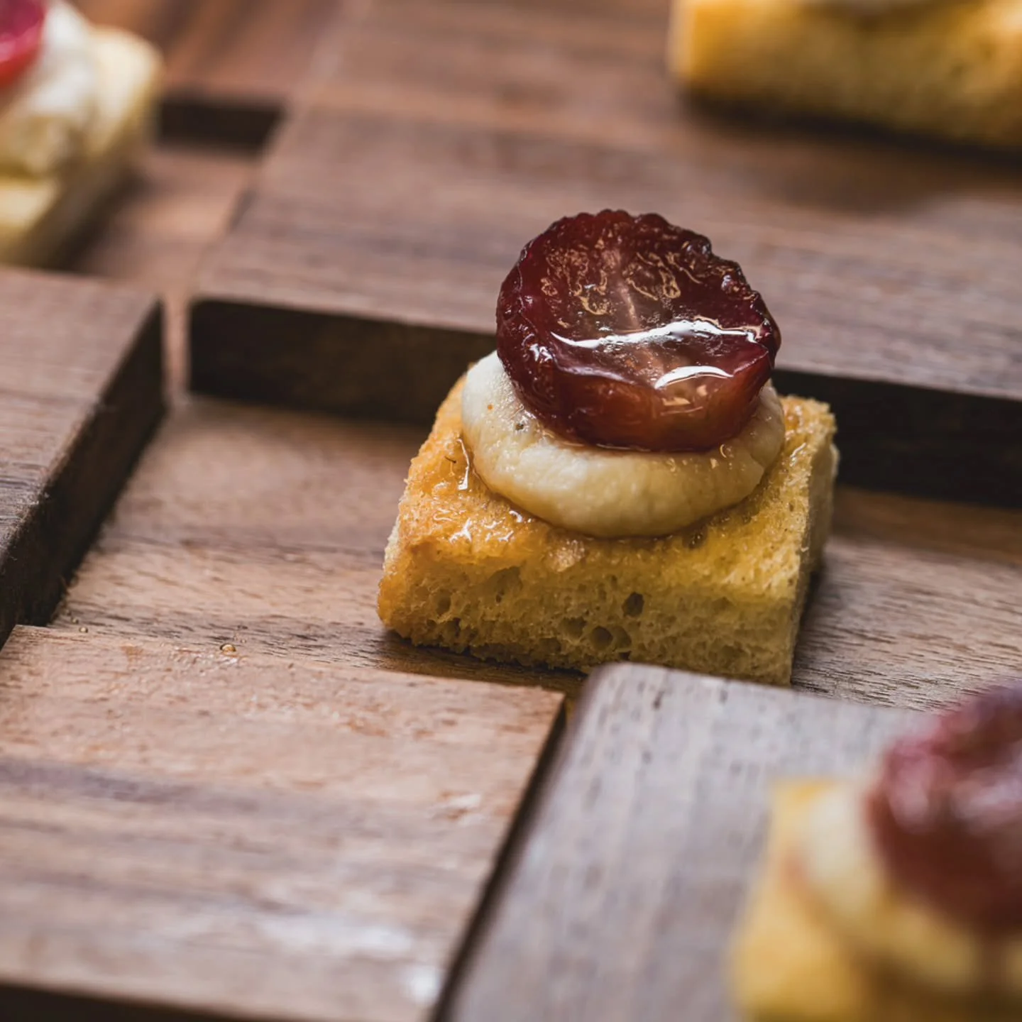 Hors d&rsquo;oeuvres are a holiday party staple. One bite pops of flavor presented on stylish platters served with a smile by our service team.

This one is a Skosh team favorite: thyme roasted grape, whipped herb ricotta, truffle honey, sourdough cr