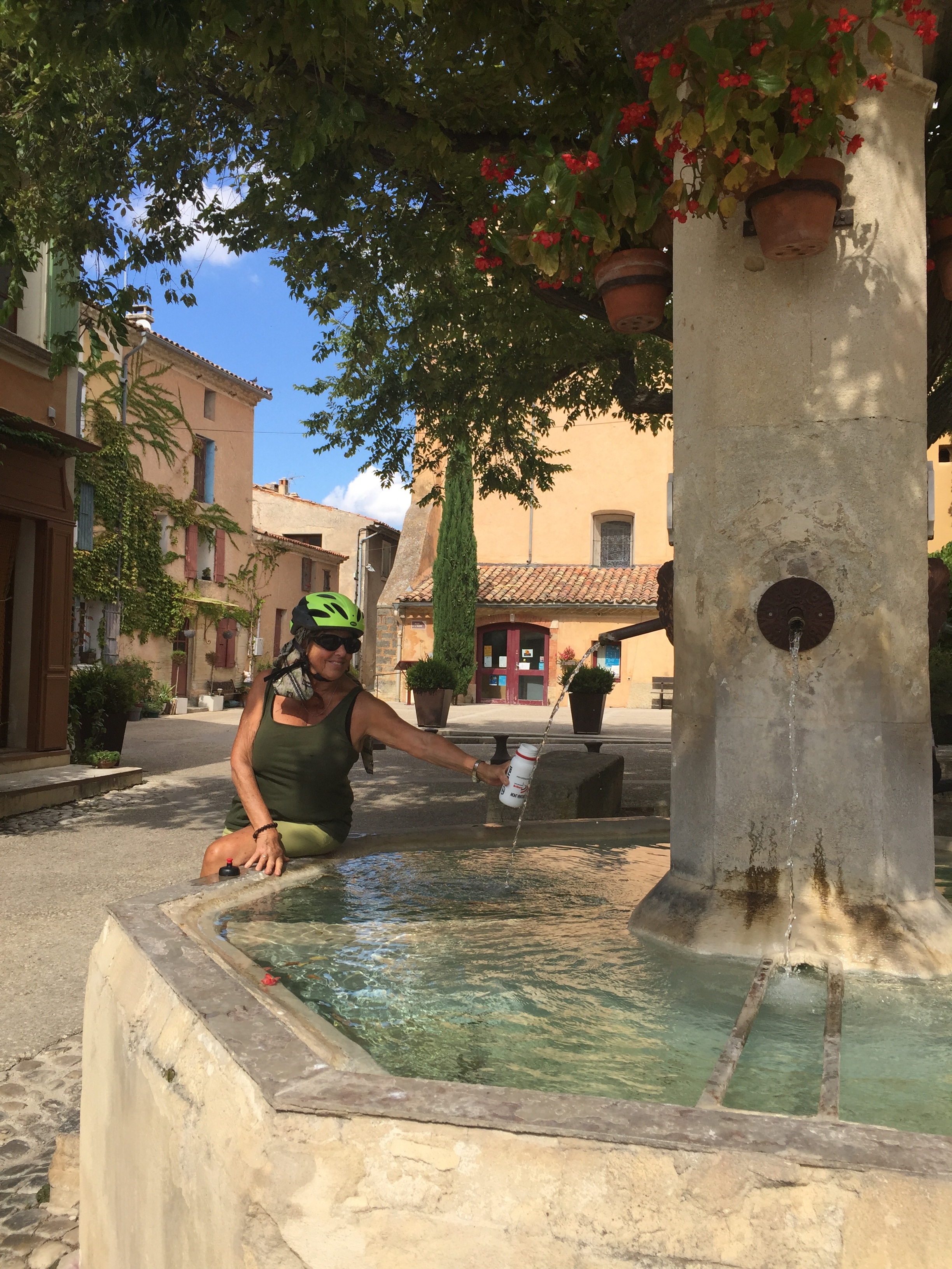 Filling water bottles at a village fountain