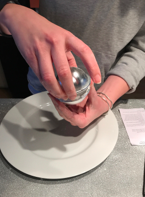 Tap very lightly and then gently remove the top first.