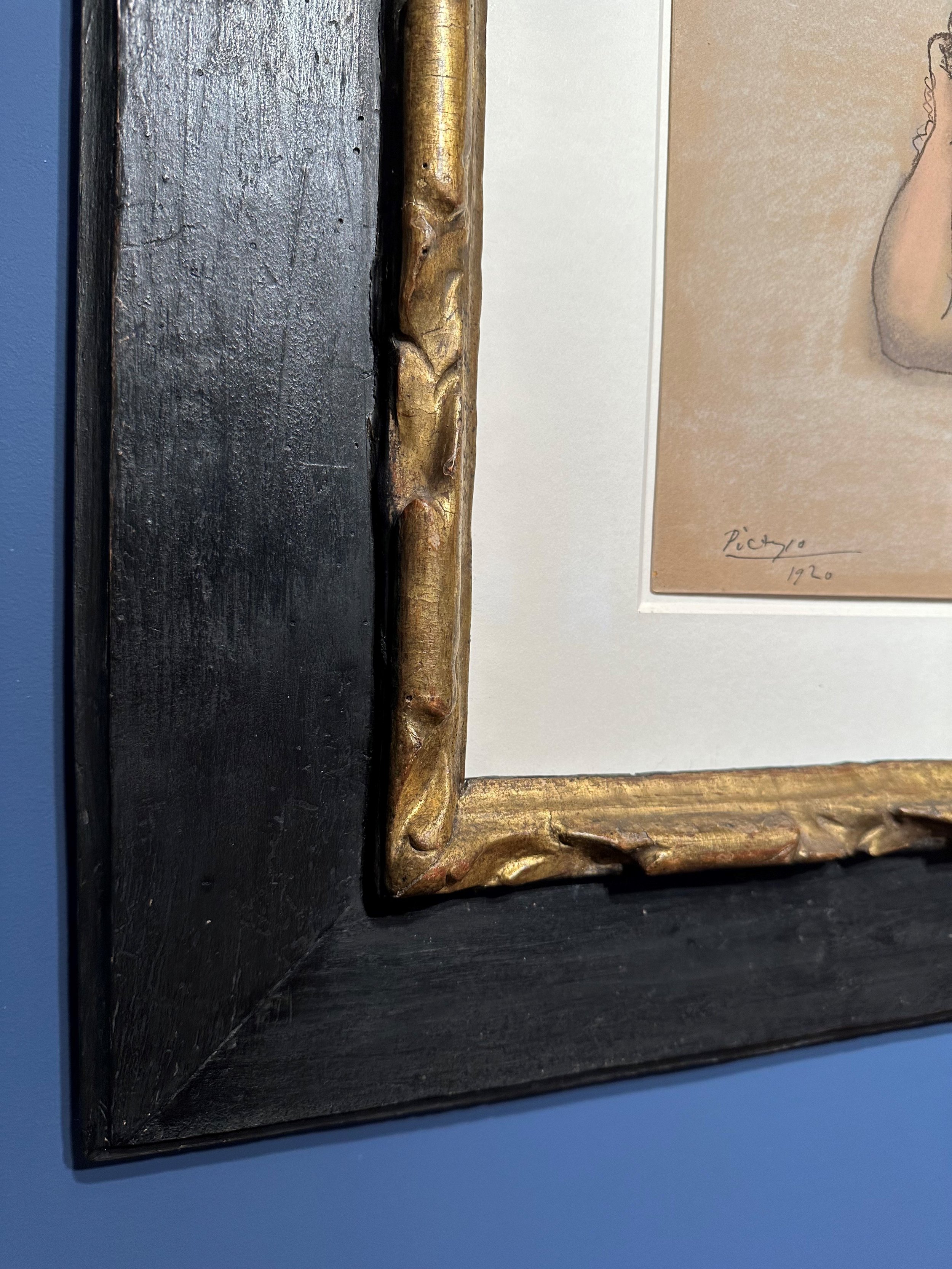 Italian, 17th century, carved and gilded cassetta frame with painted black frieze
