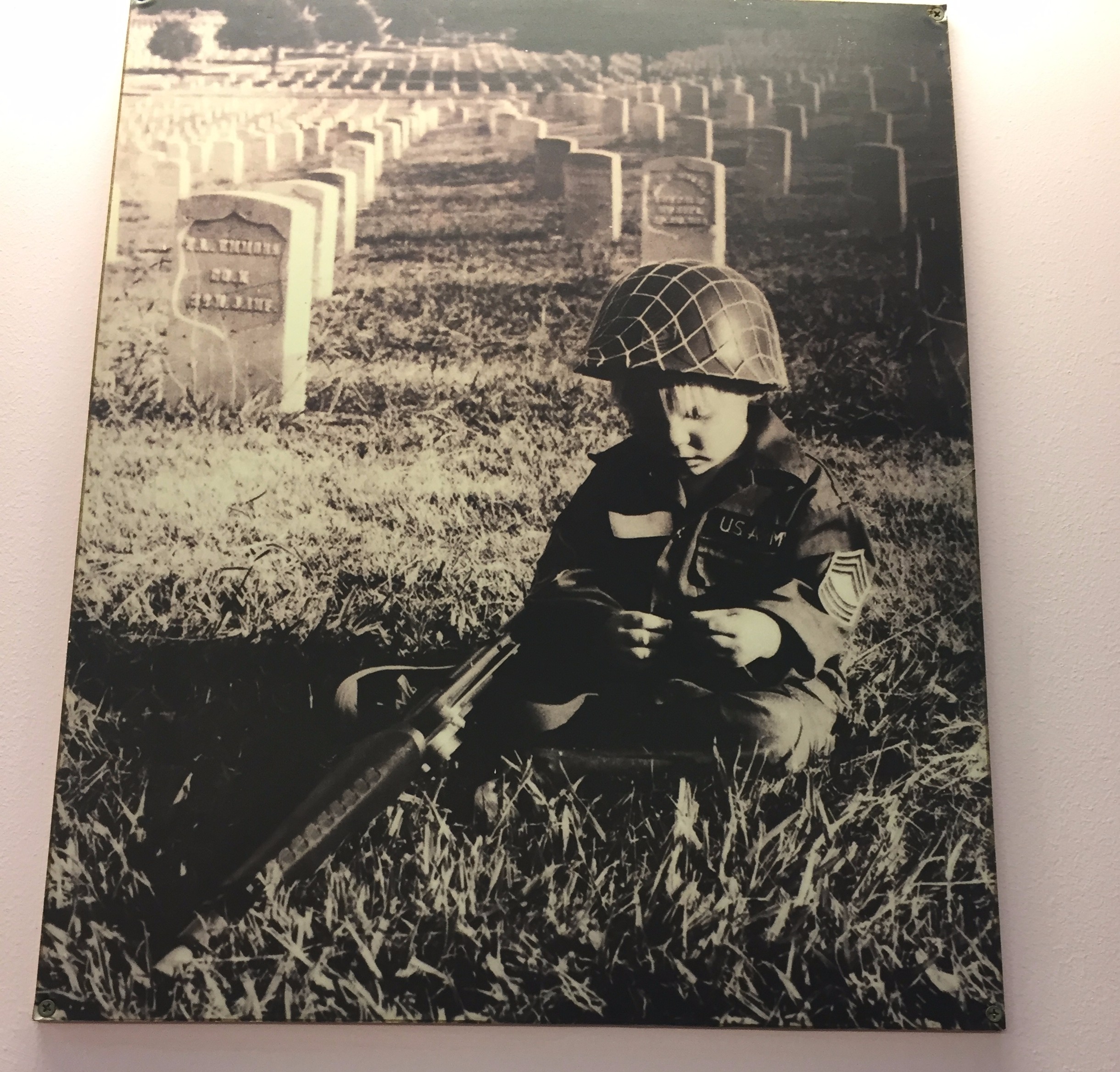 The poem below this photo reads: When I was a child / I spoke as a child / I understood as a child / I thought as a child / But when I became a man / I put away children's things