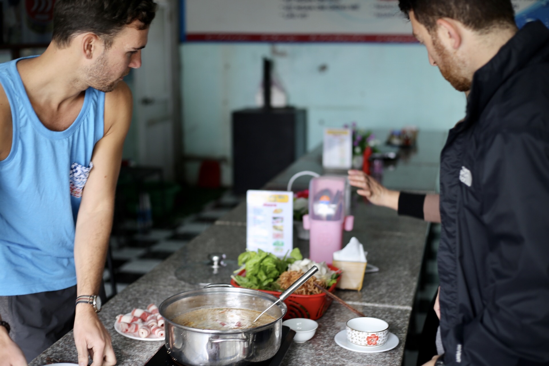 We had no common language with a hot pot restaurant on the way to Ninh Binh, so the owner had to teach us how to make our own lunch. (p/c: Sarah Hoffman)