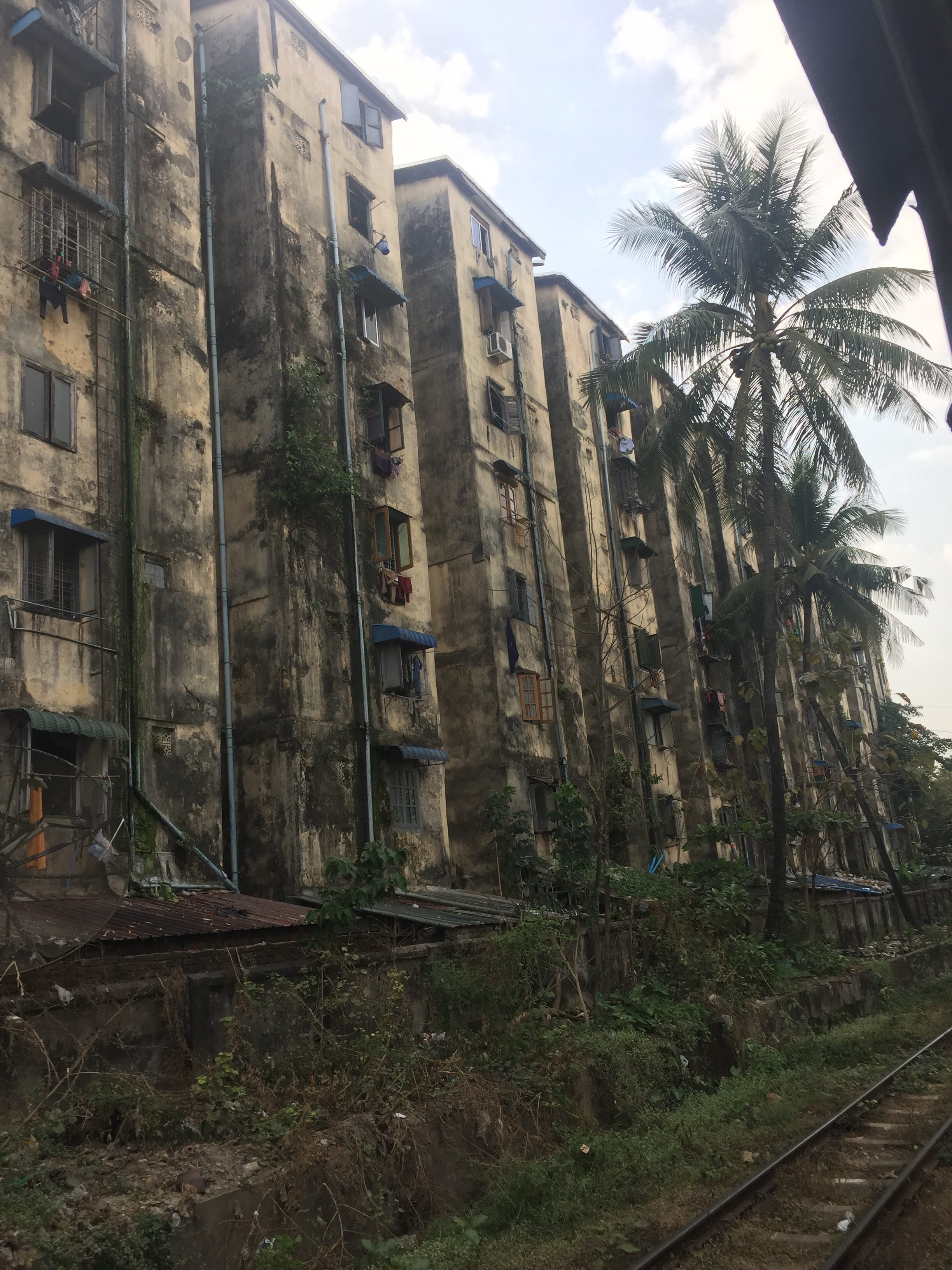 Slums, likely unkempt for years, along the railway tracks.