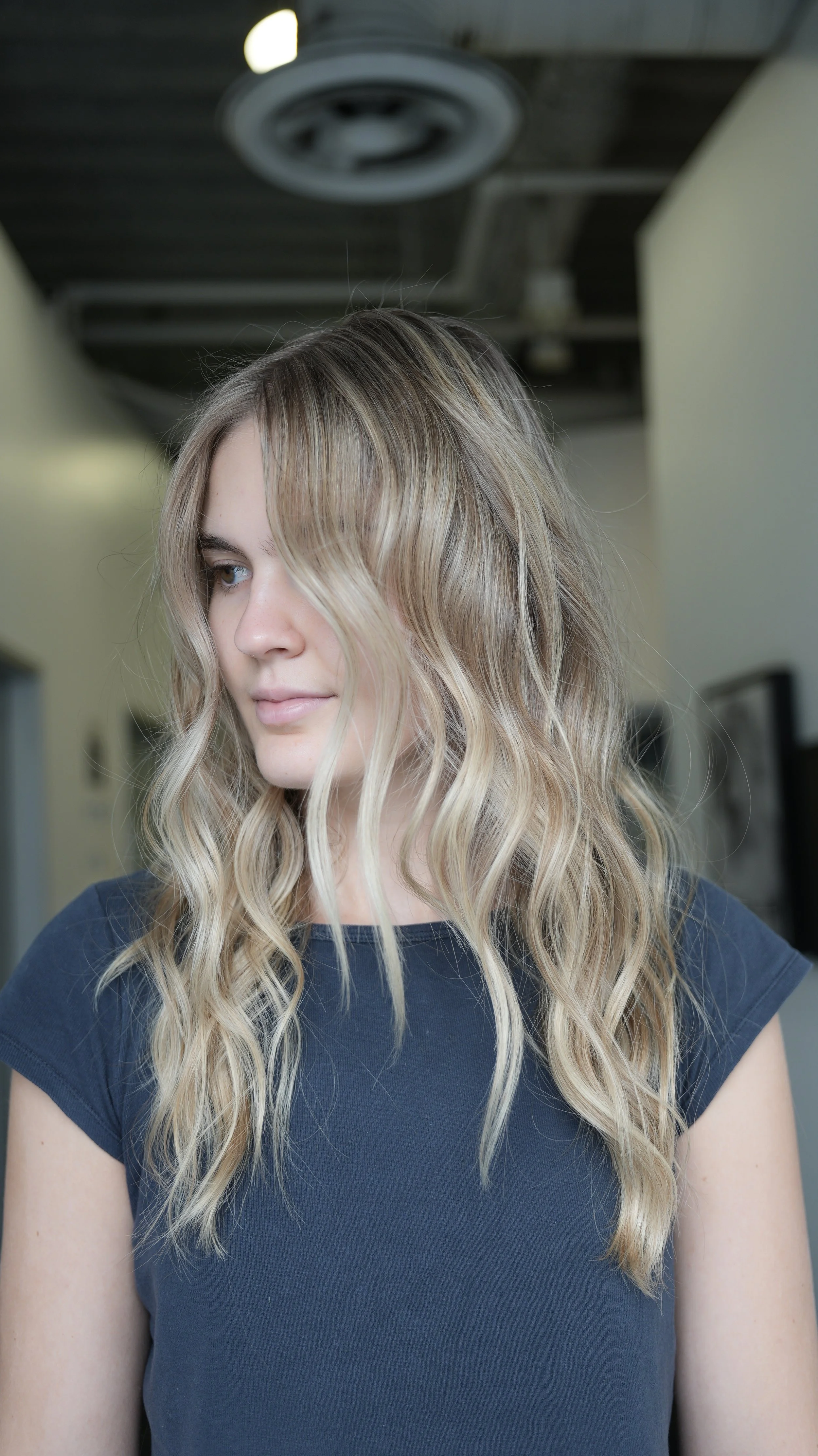 Blonde hair with blended highlights and subtle depth between lighter strands.