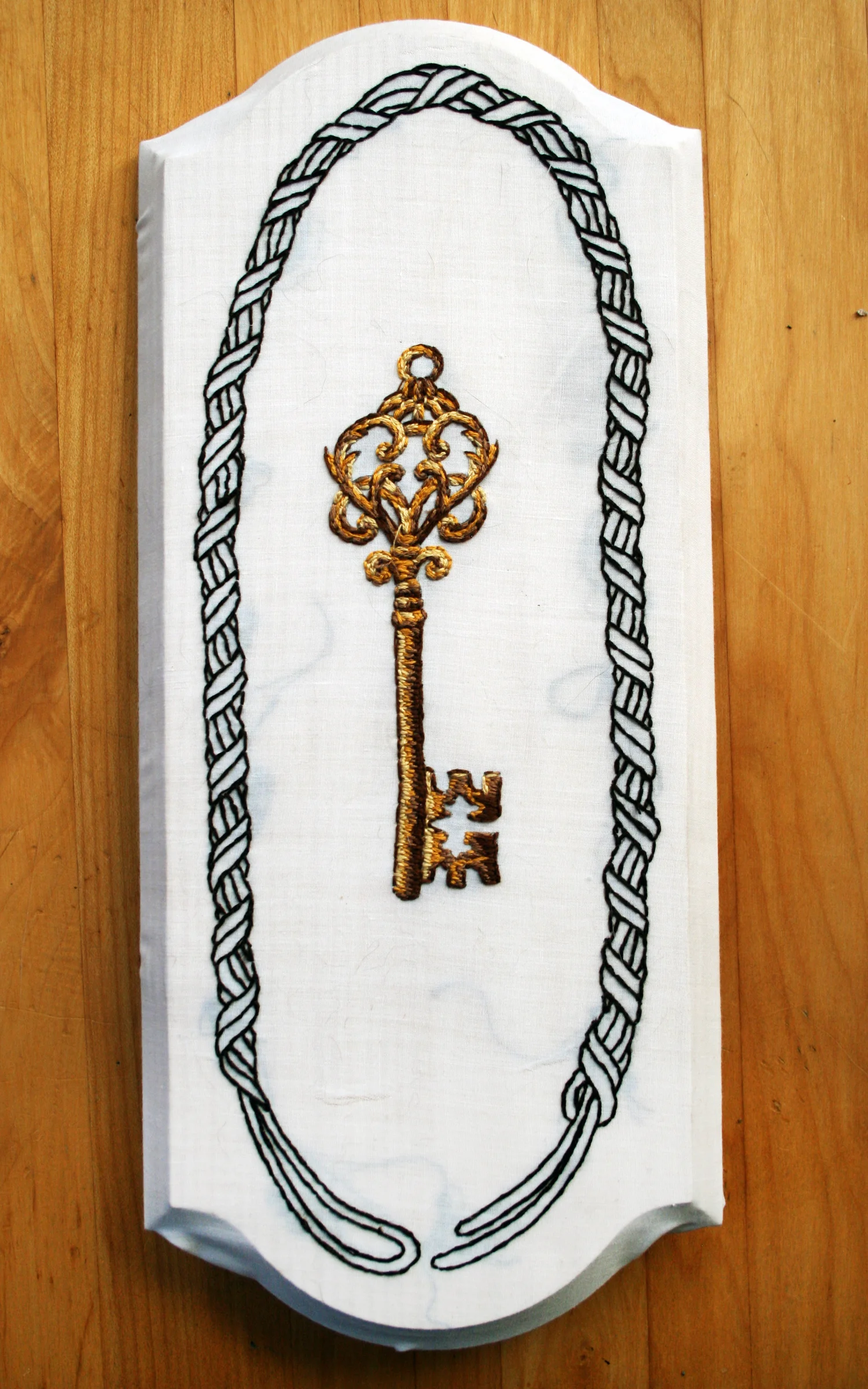 Key, 4in x 12in fabric on wood block.