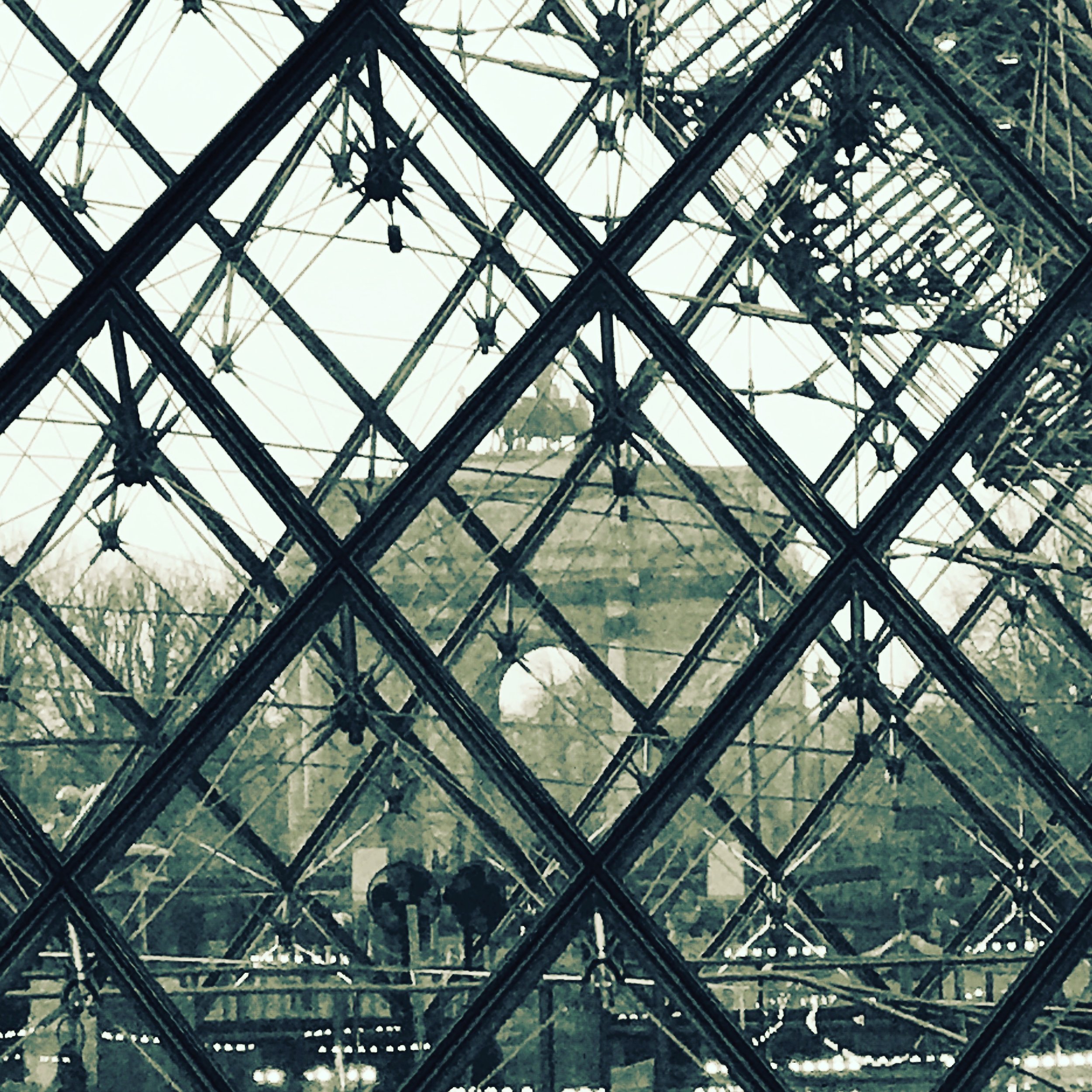 Through The Pei Pyramid (du Louvres) in Paris and we can see Le Petit Carousel!