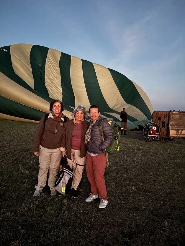 We were up before sunrise for a hot air balloon flight over the Maasai Mara. It was Kate and Jessica&rsquo;s first time, and the takeoff alone was an adventure &mdash; the balloon laid on its side, and we climbed in and reclined on our backs until it
