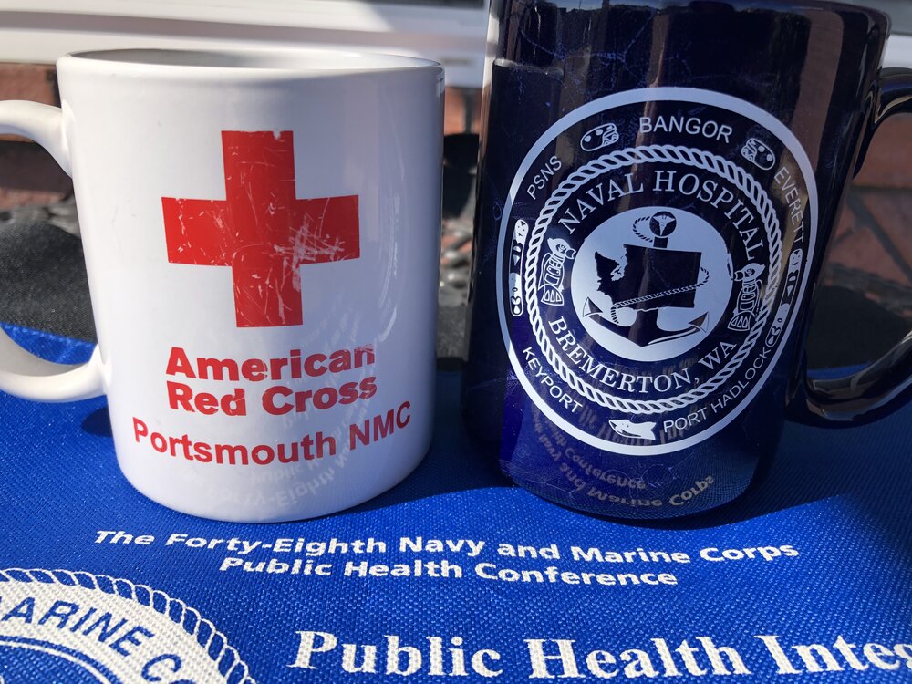 Red cross mugs pic outdoors with public health 2009 conference bag.jpg