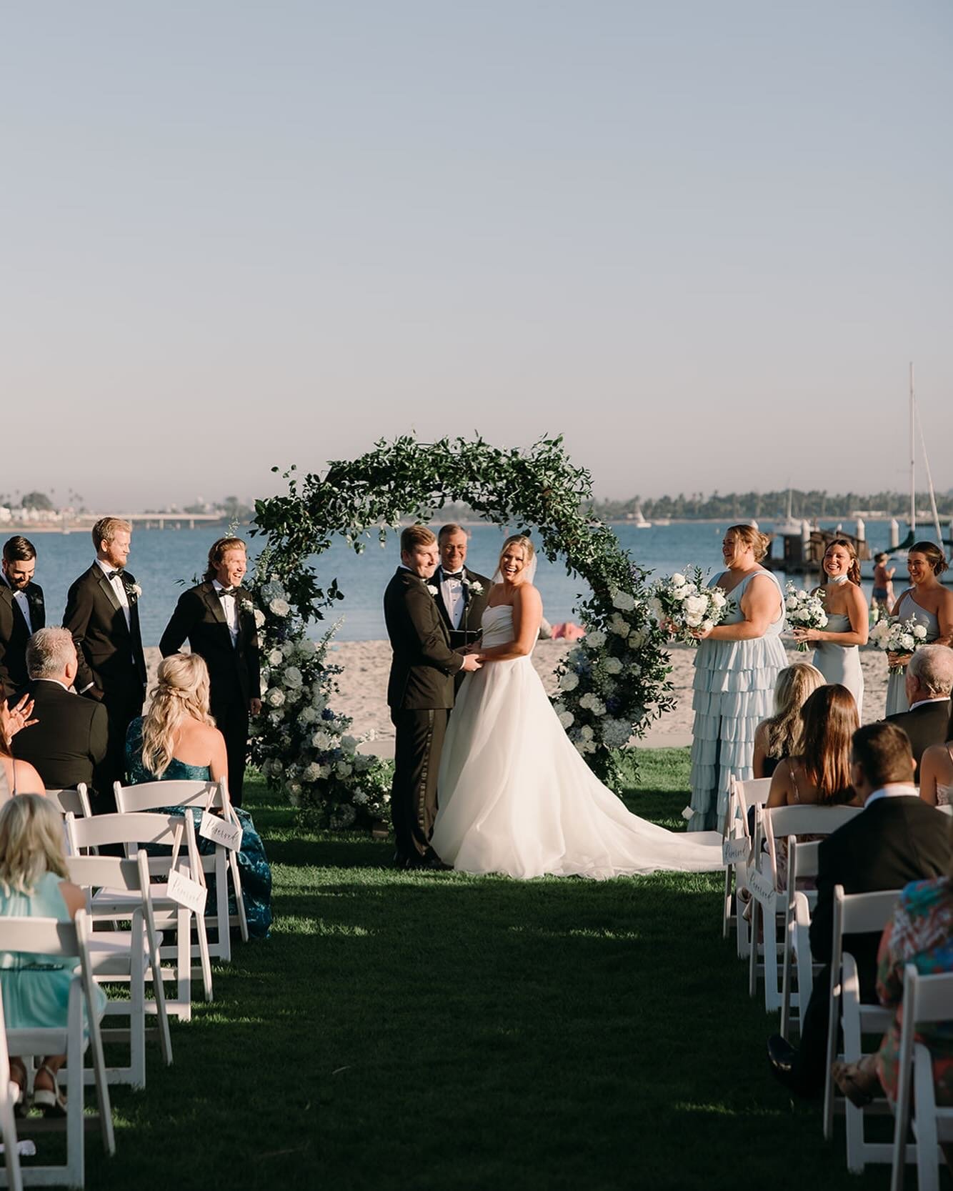 ✉️ A gorgeous day for a beach side ceremony!
*
Planning &amp; Coordination | @youreinvitedevents
Venue | @catamaranweddings
Photography | @rp.co_photo
Videography | @beyourselffilms
Florals | @mrfloralandevents
Band | @luckydevilsband
MUA &amp; Hair 