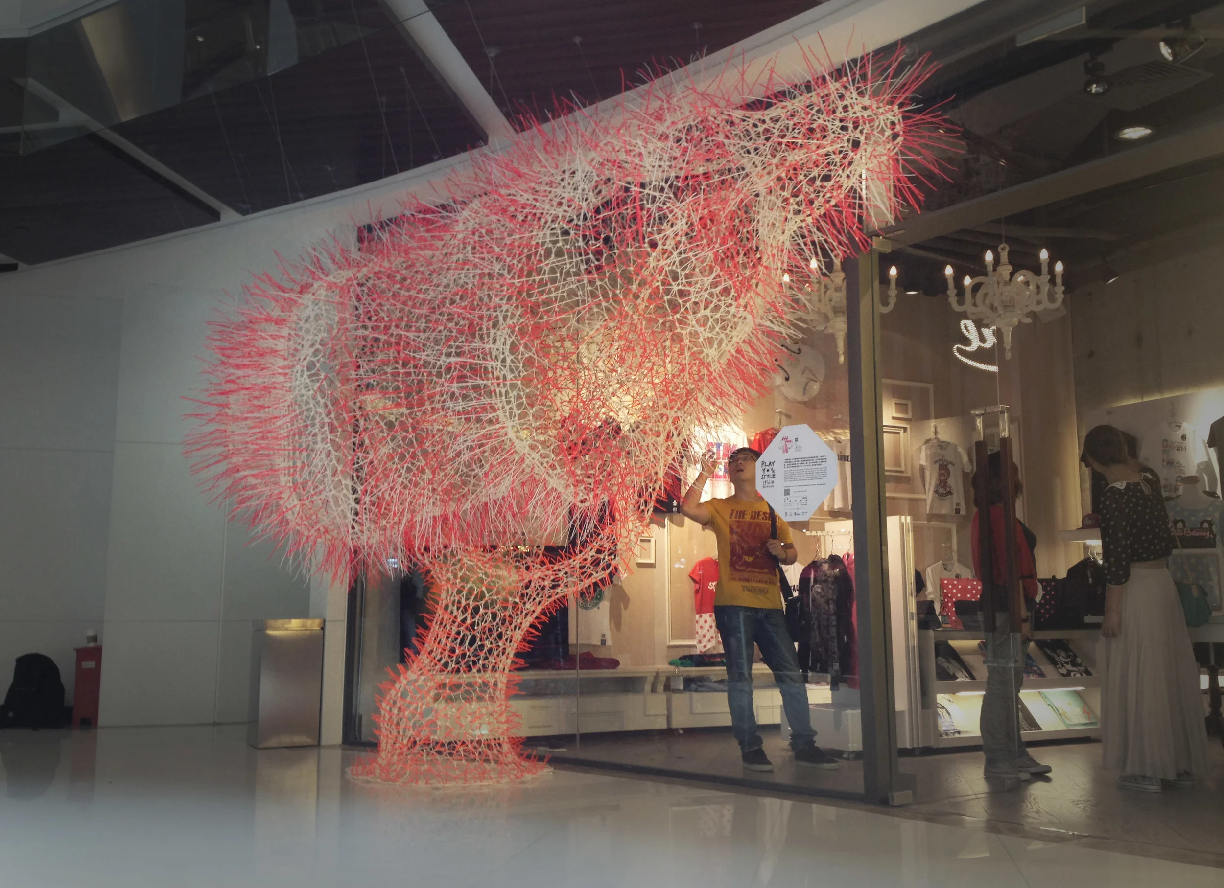 Real-i-tree is composed of over 15,000 individual cable ties woven together to form a tree like form, based on the Chinese Rain Tree, native to South East Asia. The installation is located in the Shanghai outlet of clothing brand Stay Real.