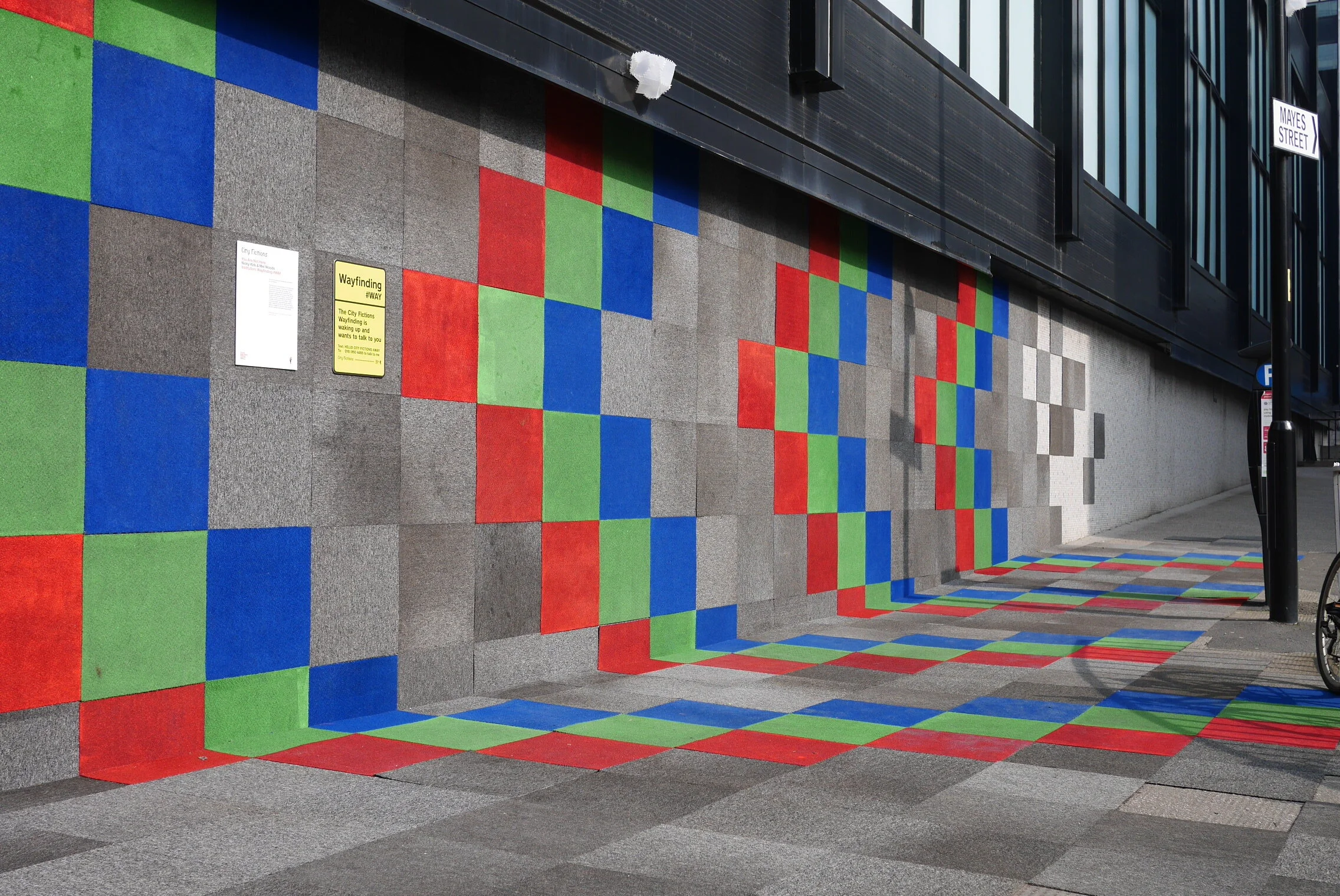  We used recycled materials from the empty offices to provide signage and navigation to the various exhibits and conferences. These included:  •	Carpet tiles as external flooring wrapping into and over wall surfaces  •	Filing cabinets as used as plan