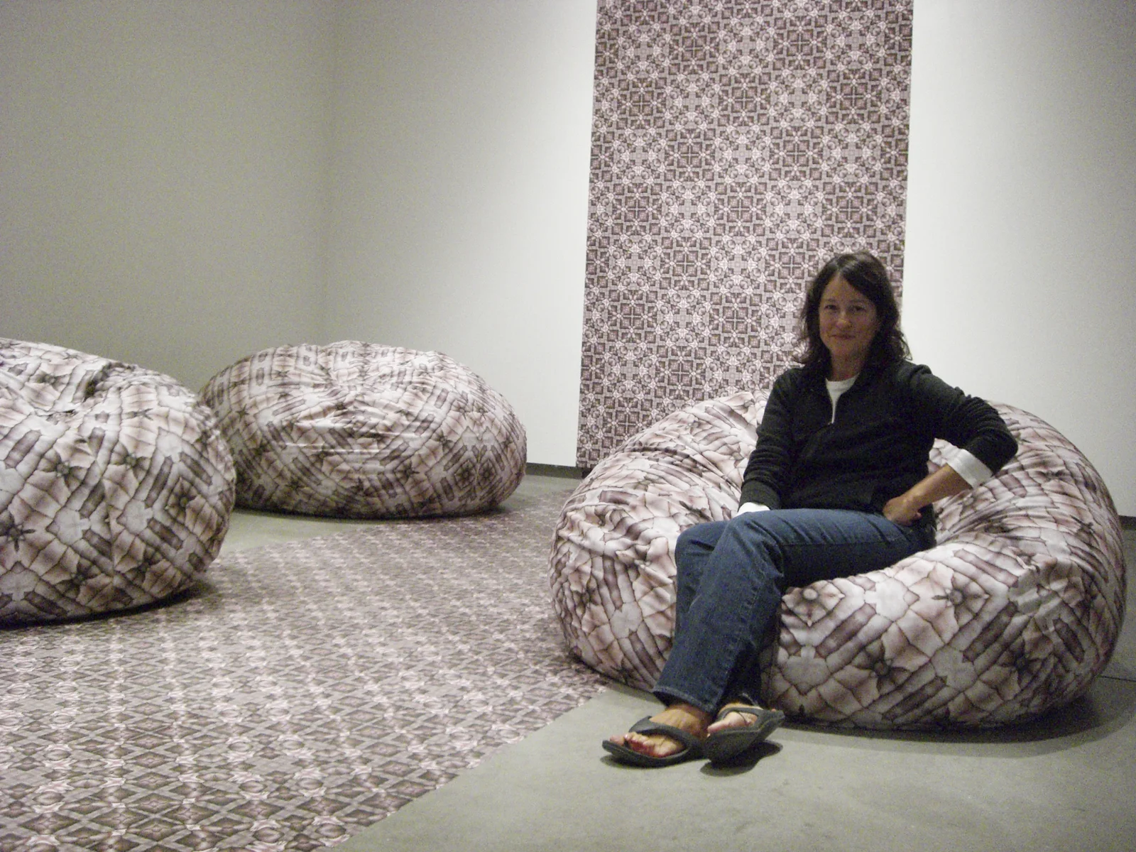 Jenny seated in her We Are Family Installation, ICA @ MECA