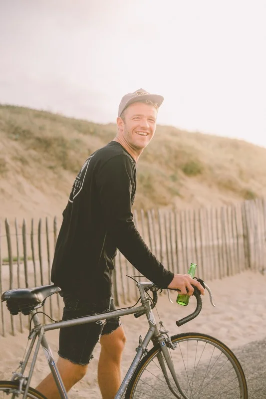 Happy guy with bike and beer