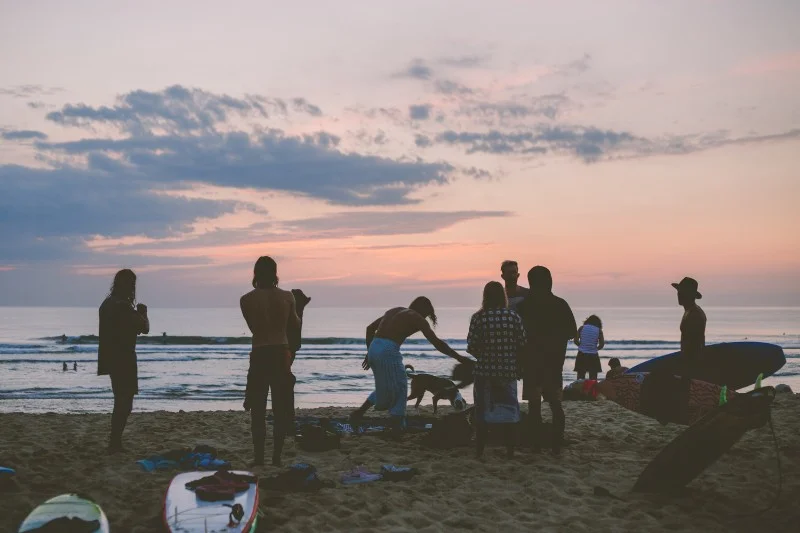 surf house guests enjoying a sunset surf