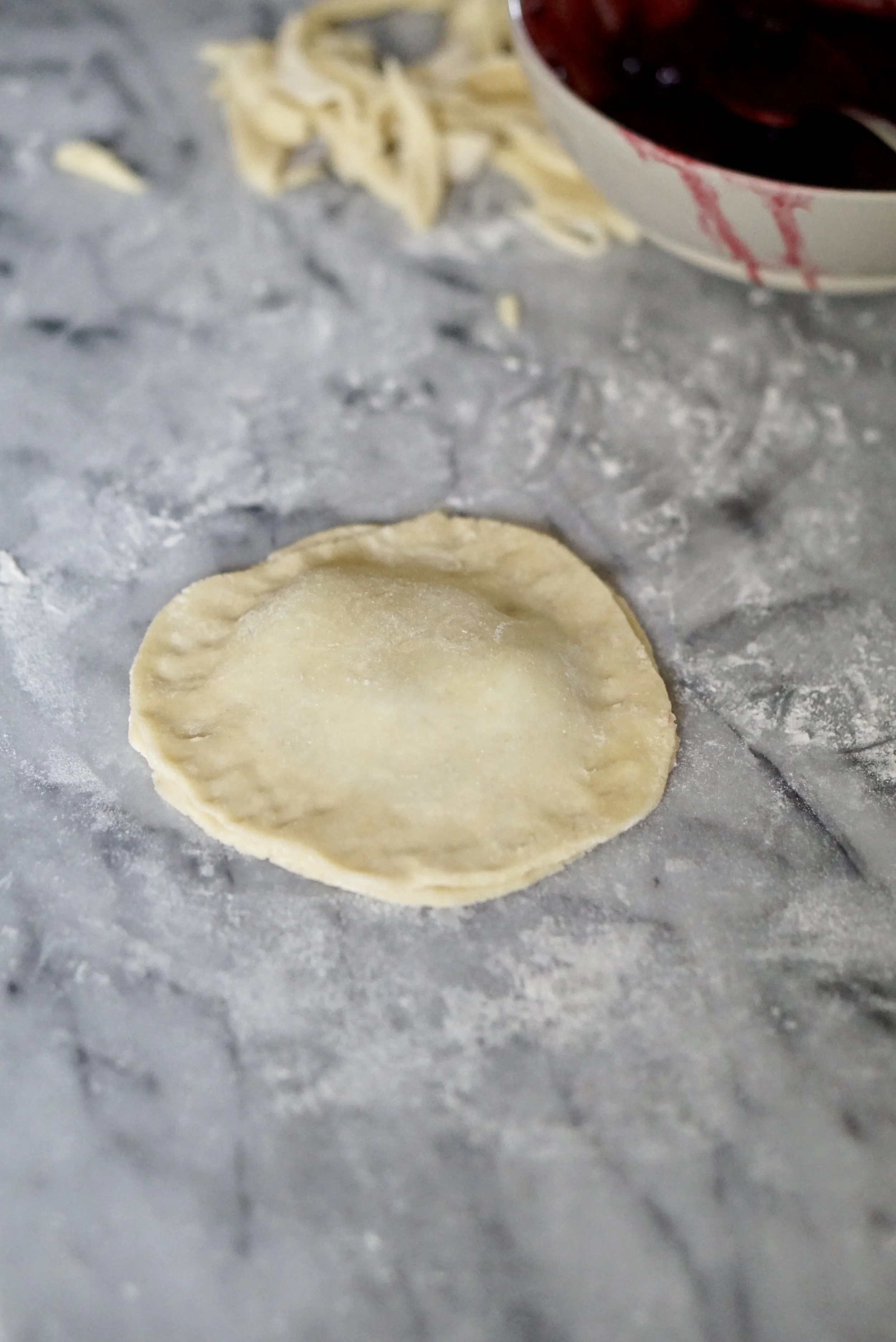 Cover and lightly seal filling into the dough discs. 