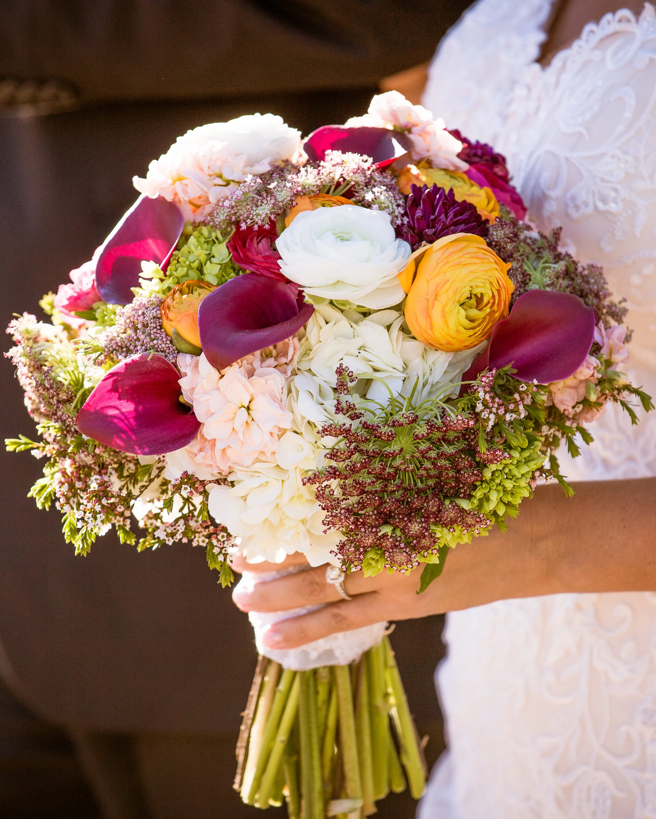 We filled Nichole's bouquet with rich jewel tones. Hints of Tennessee Orange add a bit of warmth to this beautiful array of seasonal Fall flowers.