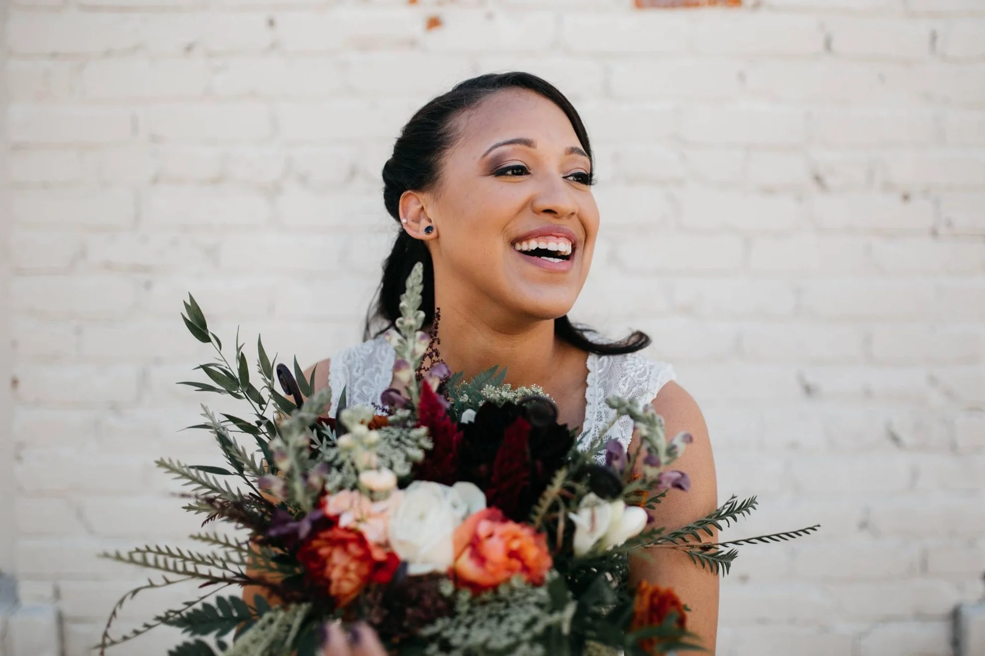 We took care to create a bridal bouquet which incorporated Whitney's request for something wild and hand-tied, trailing ribbons and lace, and also reflected the kind-hearted warmth she brings with her wherever she goes.