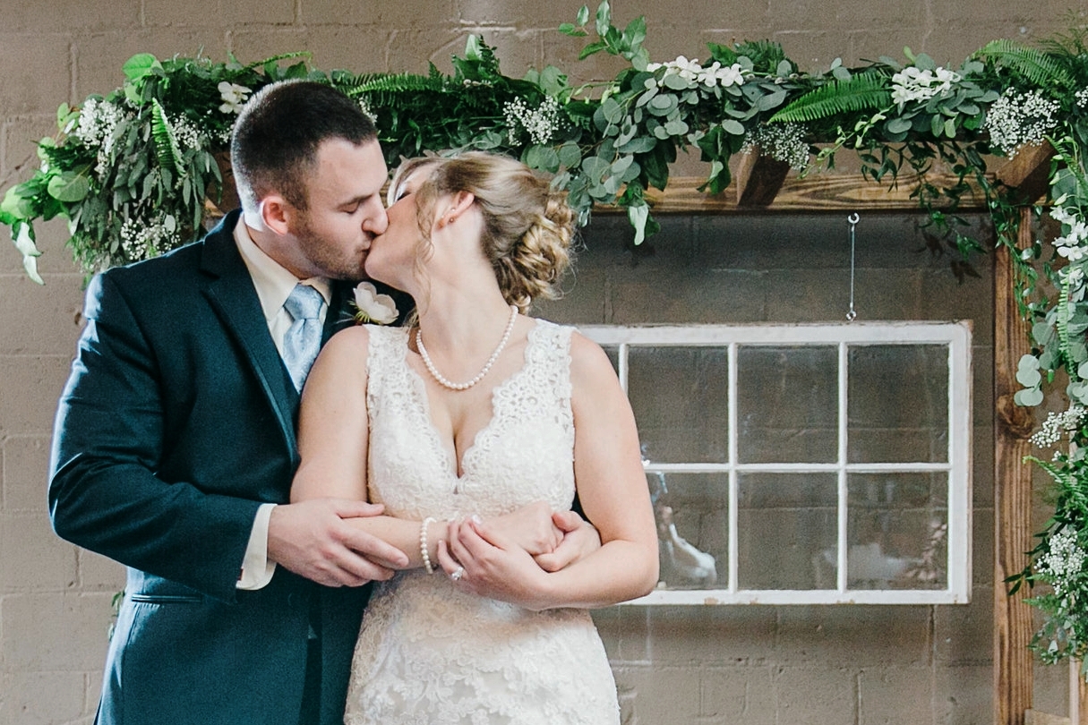 The Fox & Fern arbor was a beautiful backdrop for their wedding at The Granfalloon, decked out in greenery and baby's breath.