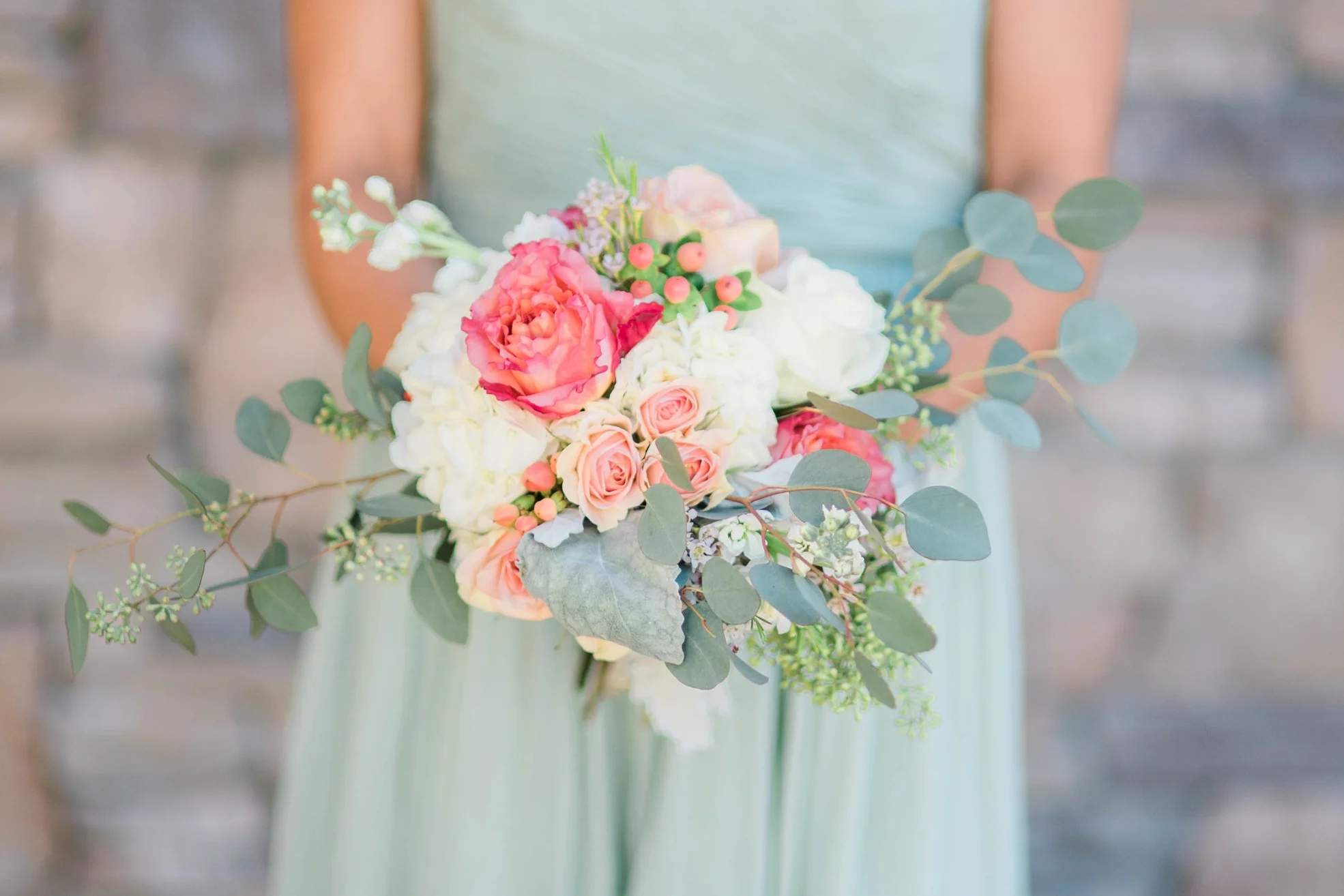 Courtney's bridesmaids wore lovely sage green dresses, a perfect tonal complement to the soft yet warm hues in the bouquets.