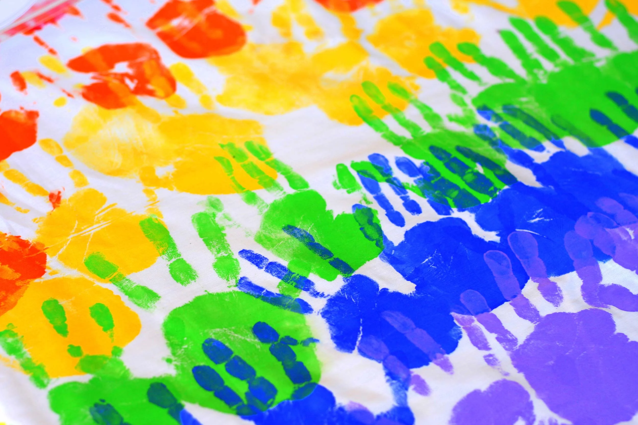 Colorful_handprints_on_a_tablecloth.jpg