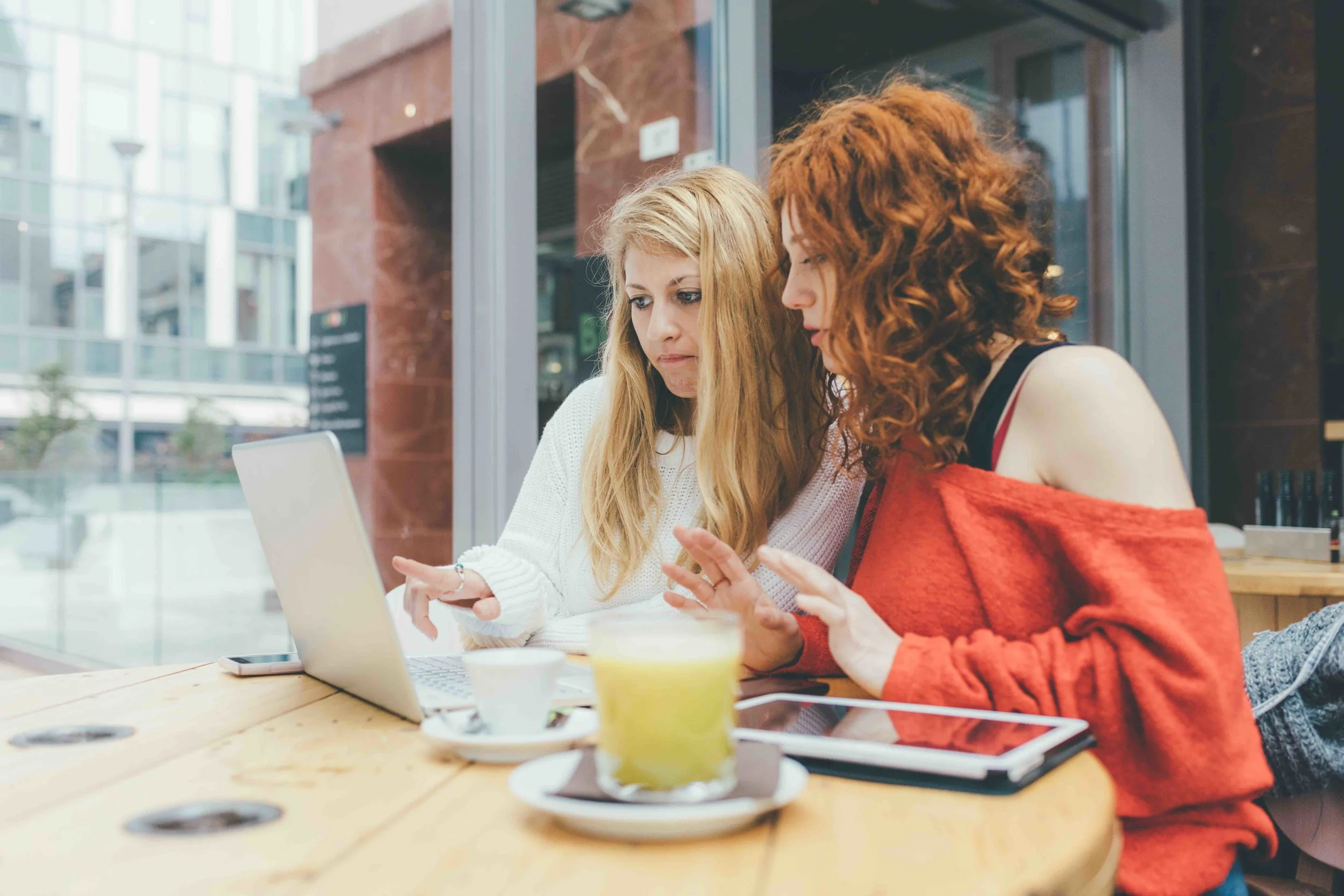 graphicstock-two-young-women-friends-using-computer-working-in-a-bar-business-studying-technology-concept_S6sC0_tJ-.jpg