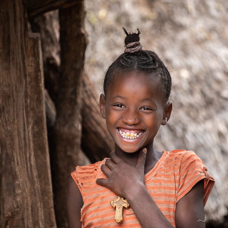 Wonderful smiles are found in the laneways in this African village