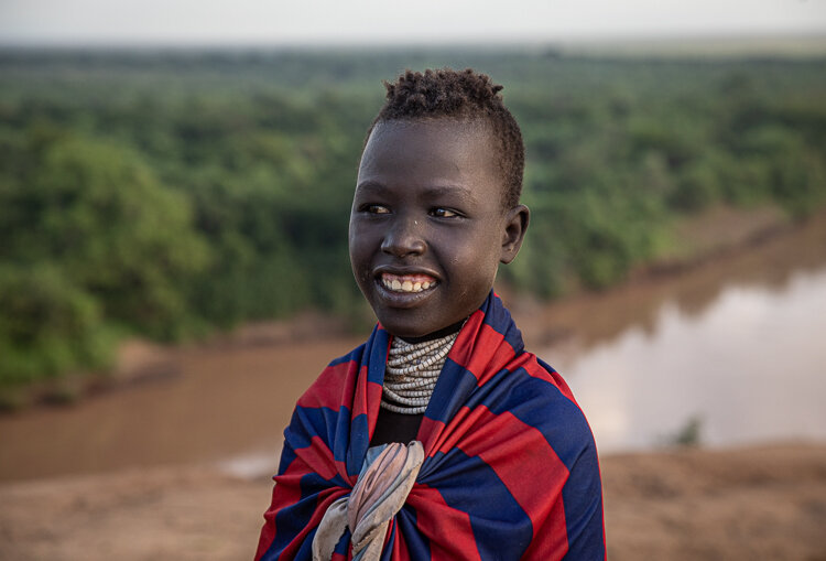 African Karo tribe girl portrait next to the Omo River
