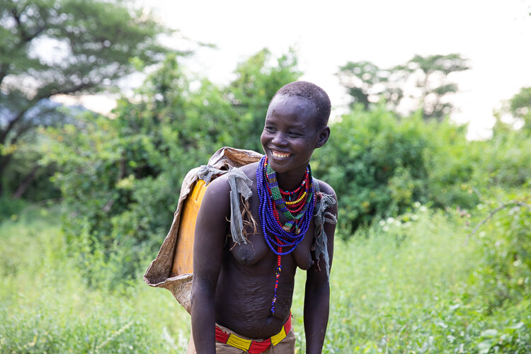 Ethiopia Omo Valley tribal photo tours with karo women smiling collecting water
