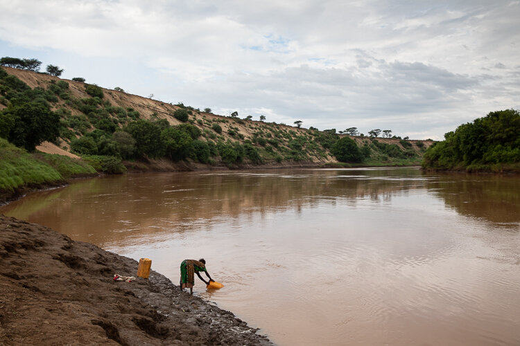 Karo Tribe woman collecting water from Omo River on Omo Valley photo tour