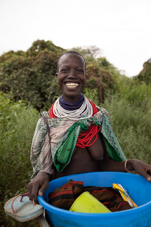 ethiopia Omo Valley Karo tribal woman carrying bowl