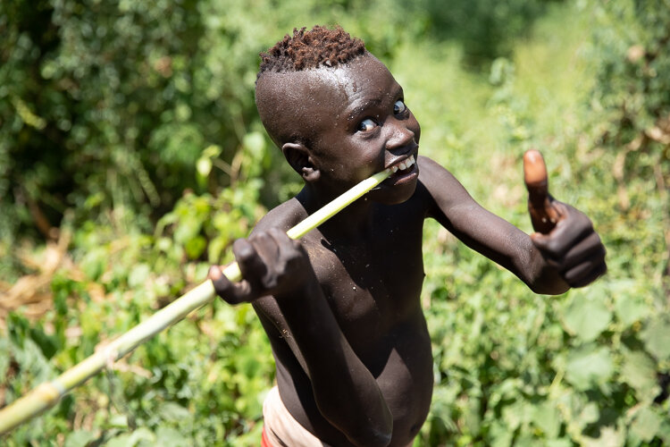 Ethiopia Omo Valley Karo tribe boy having fun