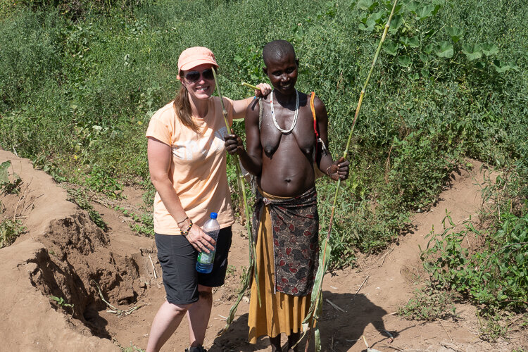 Travel photography tour guide Jayne McLean in Omo Valley tribal village with Karo woman 