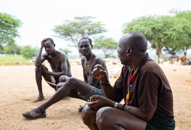 The men discuss and make decisions for the village