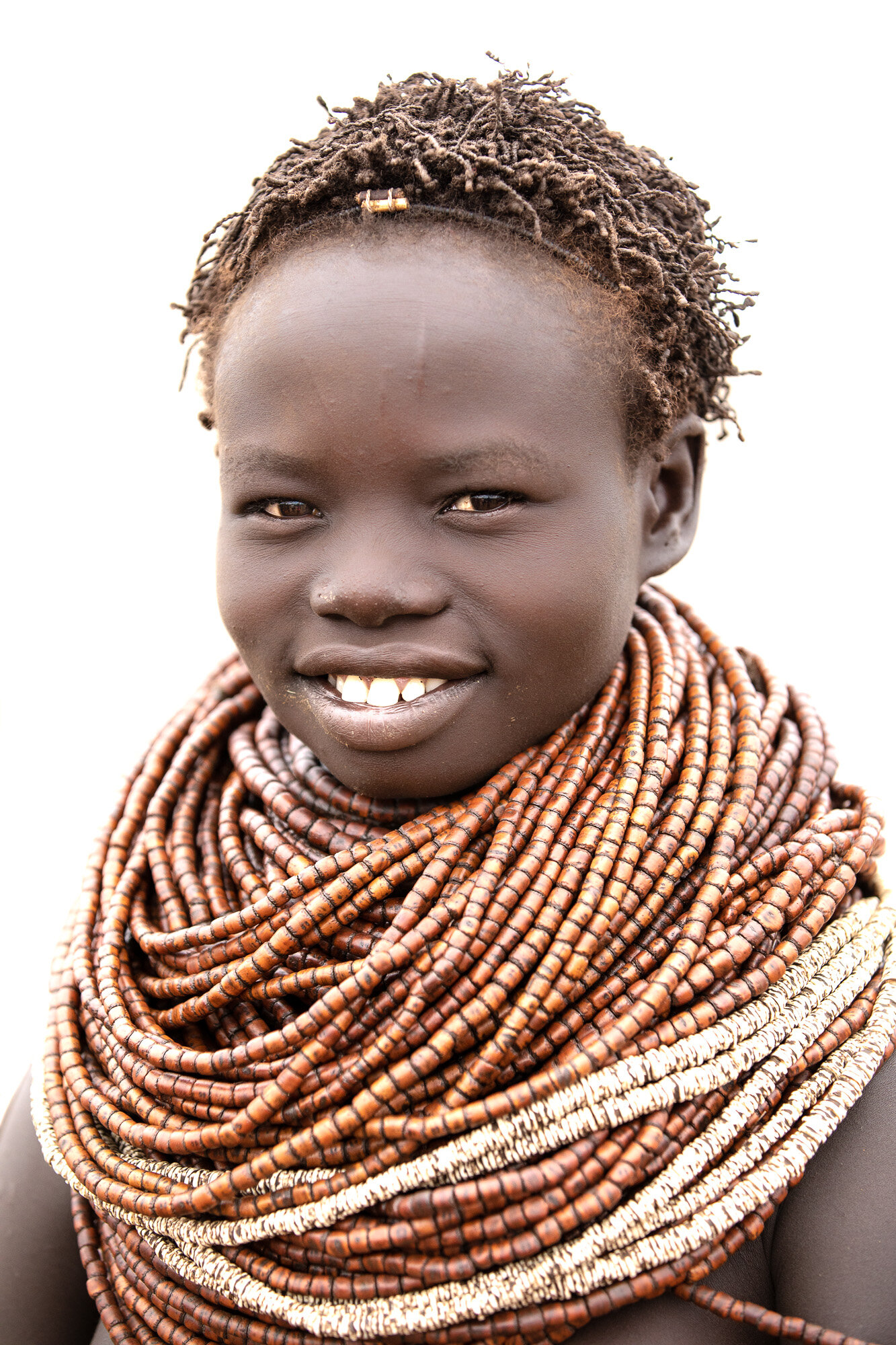 Nyangatom tribe girl with beads in Omo Valley ethiopia