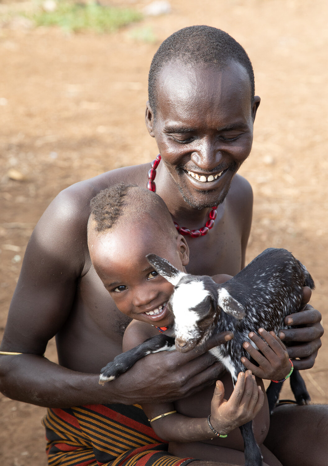 Dassanech man and child from Omo Valley tribe tour