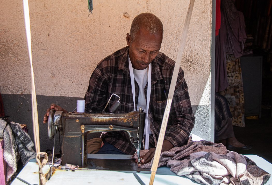 man sewing in Girgir street harar Ethiopia 