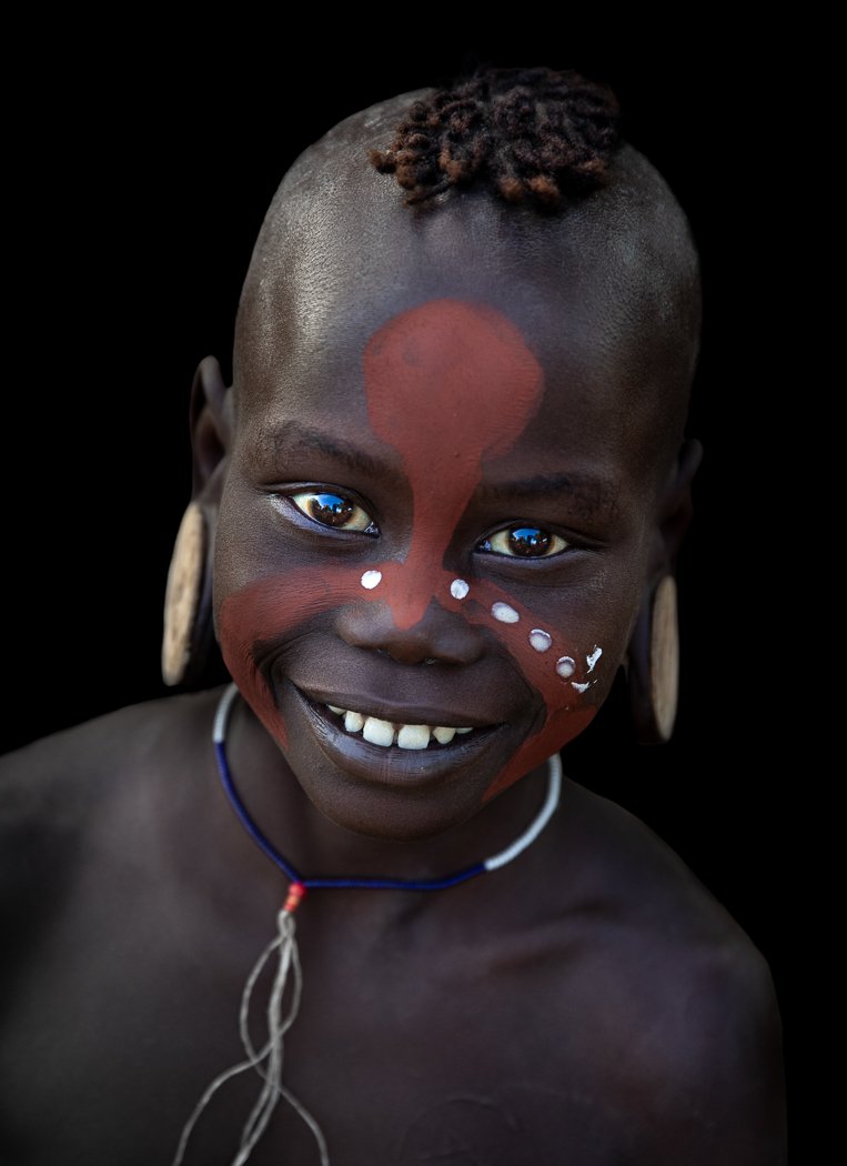 Mursi tribe girl with face paint Omo Valley tribal portrait on photo tour