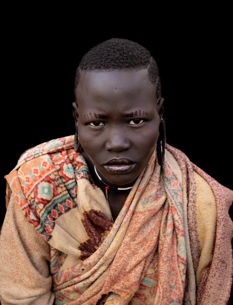 Mursi tribe woman Omo Valley tribal portrait on photo tour