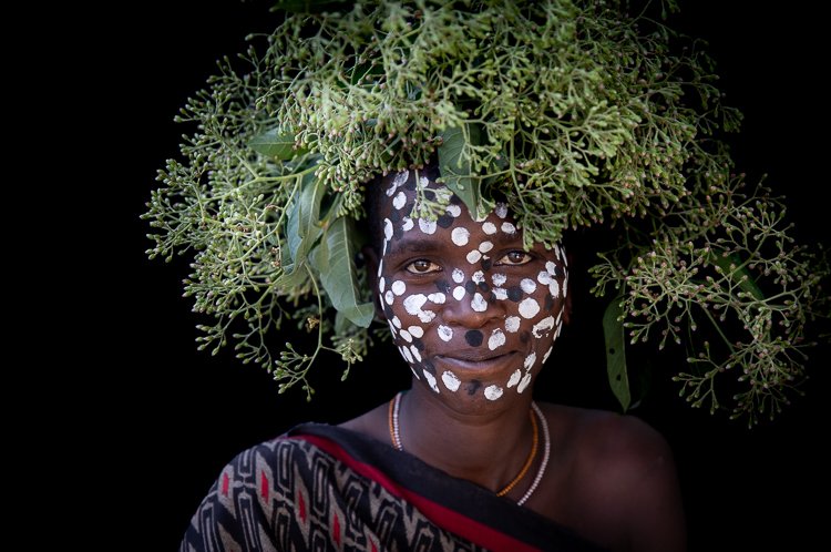 Suri Tribe woman with body paint and flowers on head