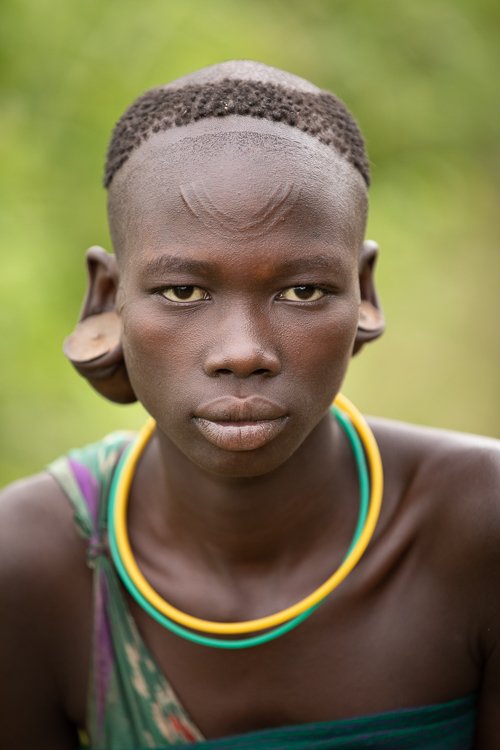 African_Surma_tribe_women_ear_plug_portraits-2.jpg