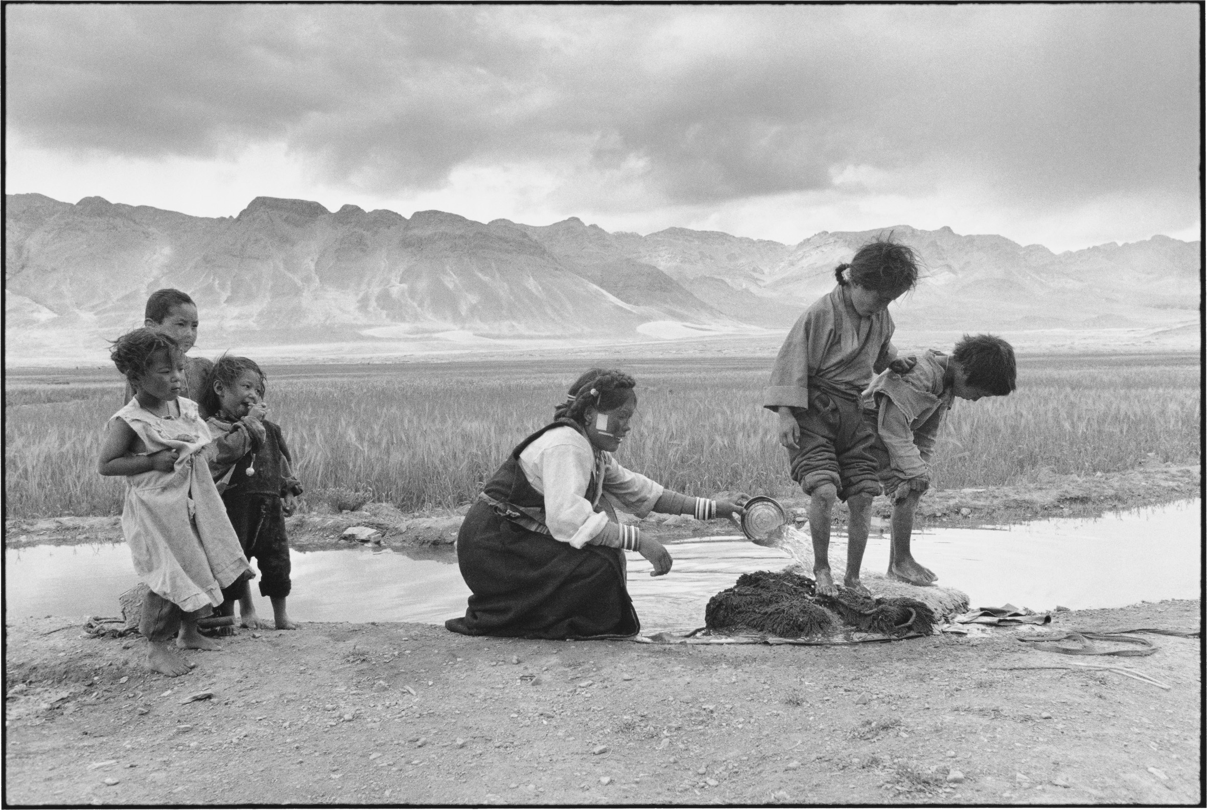 A Woman and Her Children Washing Bedding, Tibet