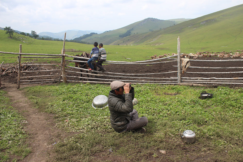 Uncle sitting at the gate, watching his sheep through the binoculars. (by Huerman)