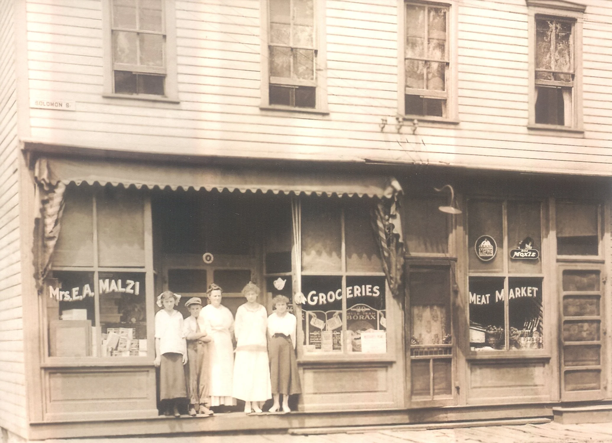 Mrs. E. A. Malzi - Groceries and Meat Market