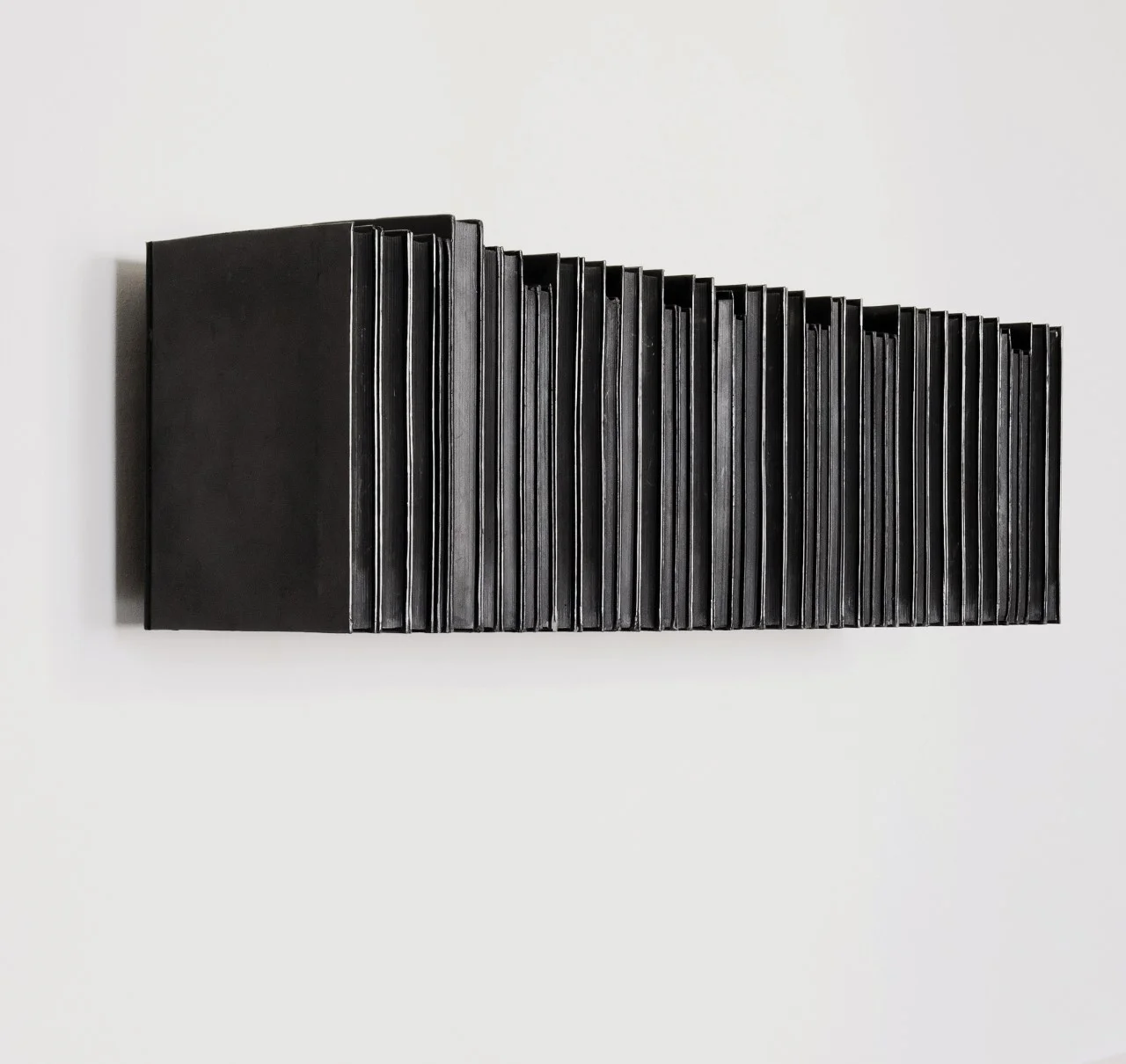 Rachel Whiteread, Untitled (Black Books) , 1997, Black pigmented plastic and steel, 30 x 101 x 23 cm, edition of 10