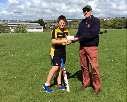 Roger Watson of the Rotary Club of Redruth presenting The Pool Academy U13 captainJarrod Hambly with the cheque.