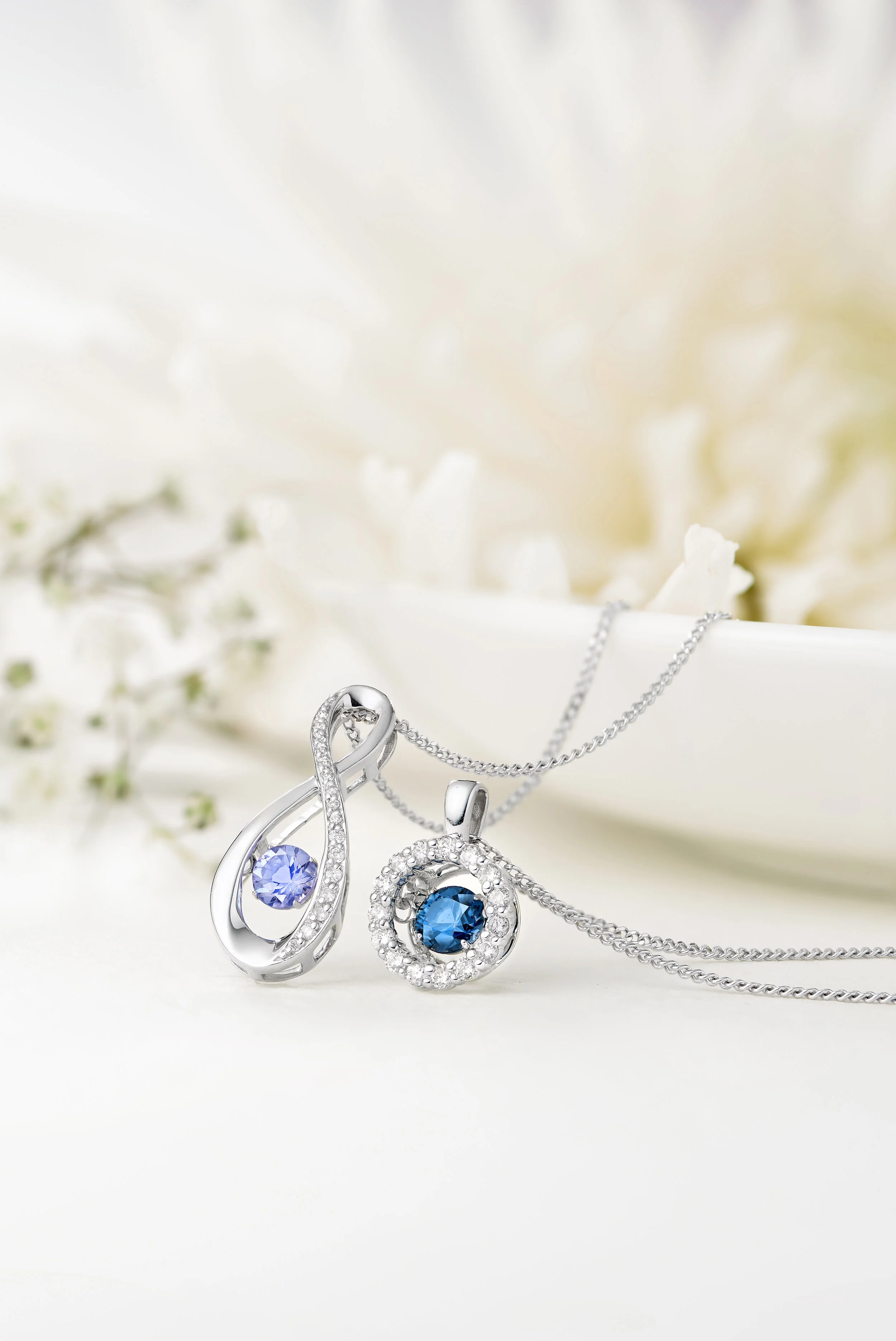 Add a splash of sophisticated colour with our Dance by Beaverbrooks 9ct White Gold Blue Topaz Diamond Pendant and the 9ct White Gold Sapphire and Diamond Pendant .