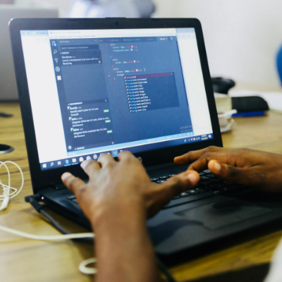 Hands of a Male Offshore Software Developer Writing Code on His Laptop